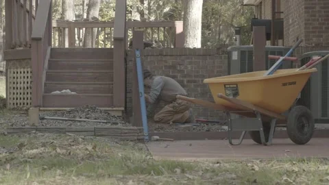 Landscape construction worker is working on patio Vídeos de archivo 144294070