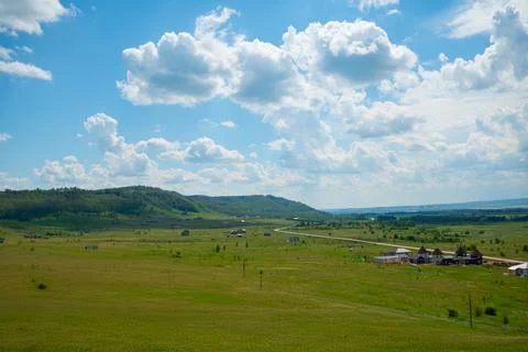 Landscape with cows and clouds Stock Photos