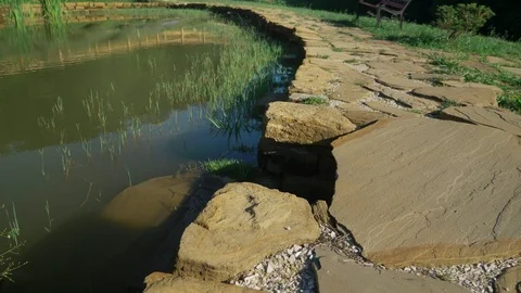 Landscape design concept. stone paved path along the pond Stock Footage 112836172