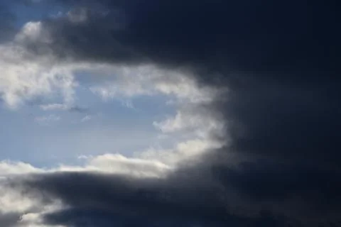Landscape with dramatic clouds against a blue sky. Stock Photos