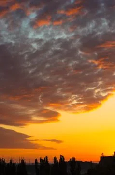Landscape with dramatic light - beautiful golden sunset with saturated sky an Stock Photos