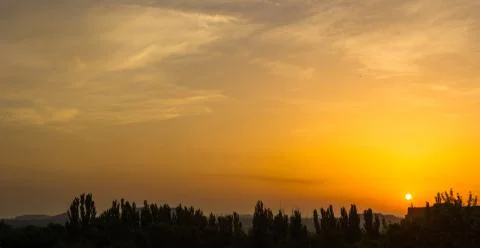Landscape with dramatic light - beautiful golden sunset with saturated sky an Stock Photos