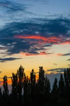 Landscape with dramatic light - beautiful golden sunset with saturated sky an Stock Photos