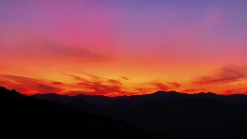 Landscape Dramatic Orange-Red Sunset Glow over Mountain Range Timelapse Video stock 332528094