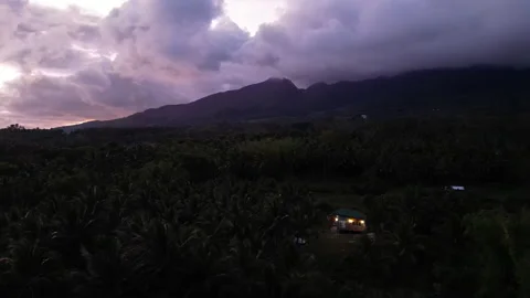 Landscape at dusk with silhouette of mountain range and house Stock Footage 307489848