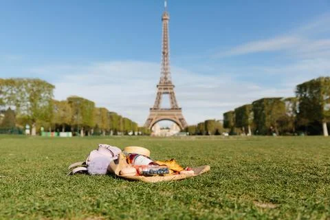 Landscape of Eiffel Tower on blue sky background. Selective focus on picnic w Stock Photos
