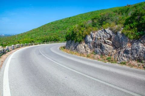 Landscape with empty road and trees under cloudy sky Stock Photos