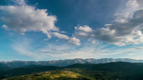 Landscape with fast movement of clouds in the sky, sunlight and shadows. Stock Footage 293095372