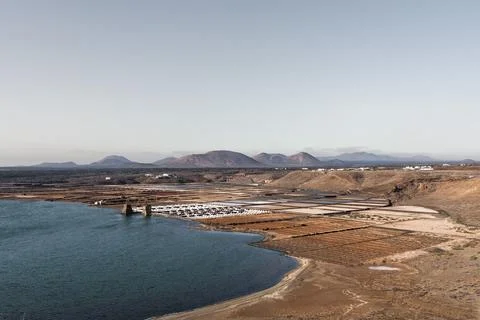Landscape featuring salt flats in salinas Janubio near a coastal area Stock Photos