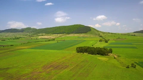 Landscape of the fields surrounded by hills covered in greenery Stock Footage 119310402