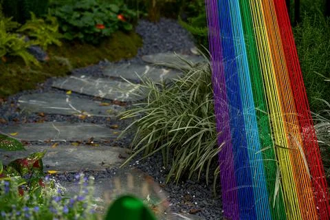 Landscape of the flagstone path next to the rainbow thread installation Foto stock