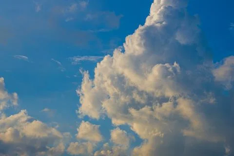 Landscape of fluffy white cumulus clouds in clear blue sky Stock Photos