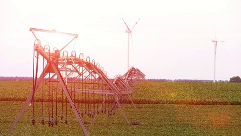 Landscape footage of wind generators and irrigation system in the soybean field. Stock Footage 72197736