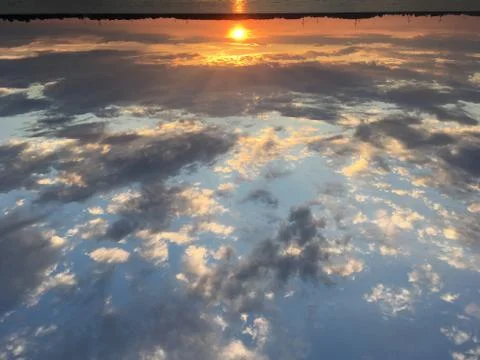 Landscape image of summer sunset on river with emphasis on sky Stock Photos