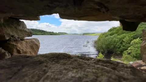 Landscape of lake between hills through the stone wall gap 動画素材 302899637