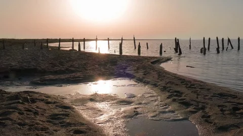 Landscape of lake with destroyed wooden pier at sunset Stock Footage 77731953