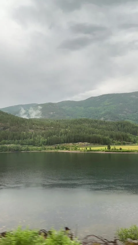 Landscape of a lake in the Norwegian mountains from inside a car Stock Footage 314949617