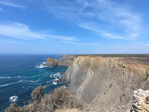 Landscape of large cliffs next to the sea in Arrifana Stock Photos