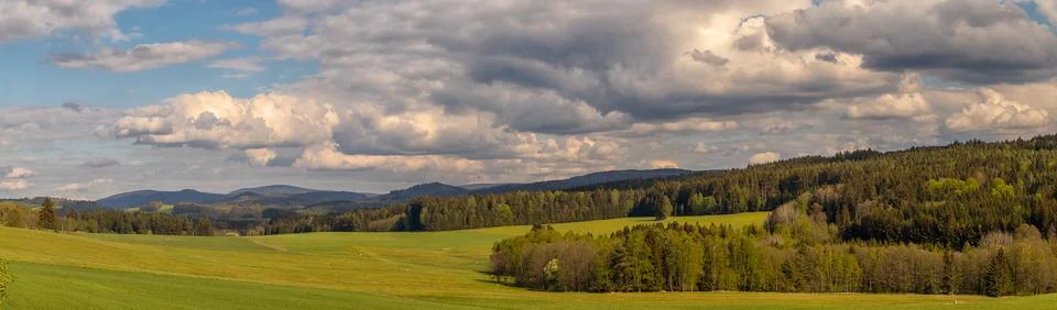 Landscape with meadows, trees, forests, in the background wooded hills Stock Photos