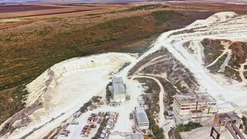 Landscape of a mining site with machinery and terrain in the background during Stock Footage 345456554