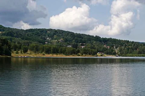 Landscape with mountain meadows, forest, small beach and residential area Stock Photos