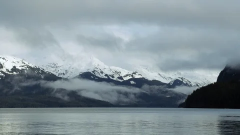 Landscape of mountain peaks covered in layers of snow on cloudy day, Alaska Stock Footage 129107580