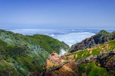Landscape with mountain range above the clouds Stock Photos