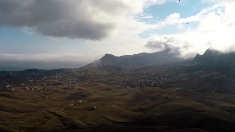 Landscape with mountain range and birds flying in the sky Stock Footage 86790476