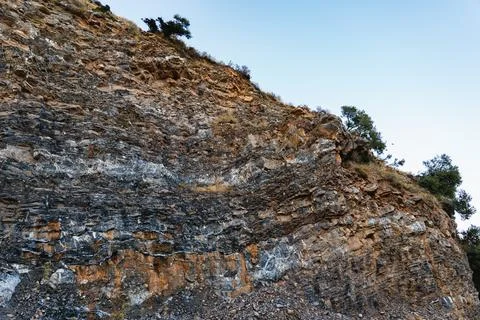 Landscape of a mountain slope with sparse vegetation and layers of limeston.. Foto stock