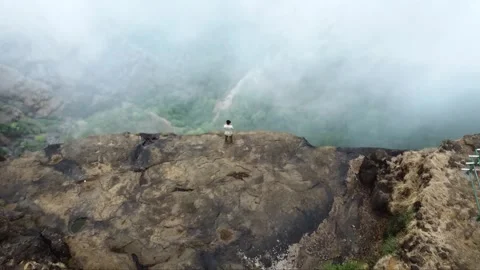Landscape in the mountains, a boy stand in the corner of mountain Stock Footage 284710672