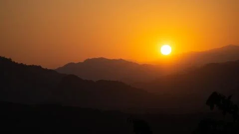 Landscape of mountains during a vivid sunset in Luang Prabang, Laos Stock Photos