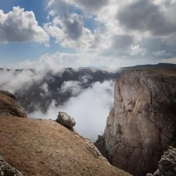 Landscape. The mountains tower over the clouds Stock Photos