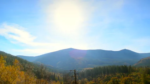 Landscape mountains with trees, blue sky, sunny day. Calm natural scene. Stock Footage 253216461
