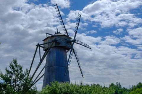 Landscape with Old wooden windmill. Stock Photos