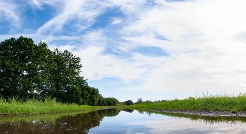 Landscape of path and puddle among fields in western Poland Stockfoto's