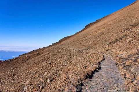 Landscape on the peak of a volcano with a view of a large slope. Stony and .. Stock Photos