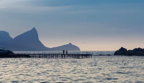 Landscape with pier and cliffs Stock Photos