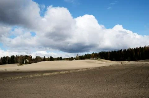 Landscape with plowed field in spring Stock Photos
