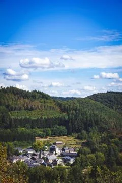 A landscape potrait of a sunny day with a blue sky with some clouds above a v Stock Photos