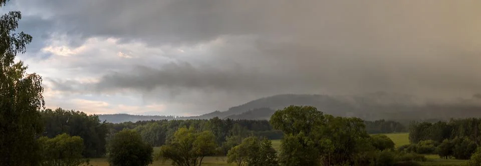 Landscape - rain, cloudy sky, partly shining blue sky Stock Photos