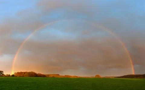 Landscape with rainbow Stock Photos