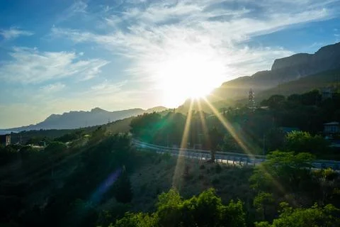 Landscape with the rays of the sun over the road Stock Photos