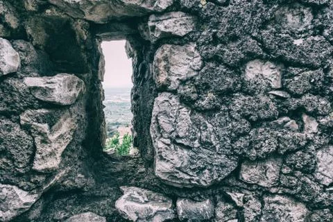 The landscape from a rectangular window of an ancient stone wall. Foto stock