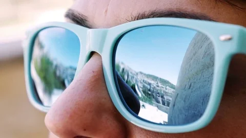 Landscape reflection in a woman's sunglasses Stock Footage 80143554