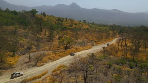Landscape Reveal Orbit Drone Shot with 4x4 Cars in Africa Stock Footage 341620837