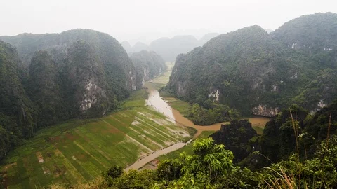 Landscape of rice fields between mountains at Ninh Binh province on foggy day Stock Footage 147351005