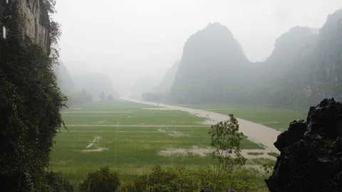 Landscape of rice fields close to hang mua peak mountain on rainy day, Ninh Binh Stock Footage 147356137