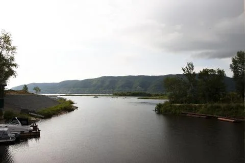 Landscape of the river and mountains on a cloudy day in summer Stock Photos