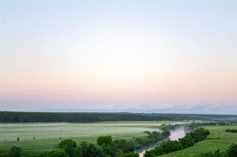 Landscape with river and trees, fields and clouds Stock Photos