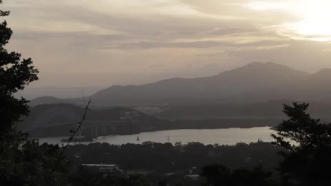 The landscape of a river with a bridge next to a city on a sunny Stock Footage 140935153